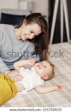 mother and child on bed, funny happy mother and son, feelings, relationship of mother and child,