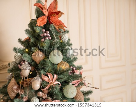 Christmas tree with decor in pastel white interior background.