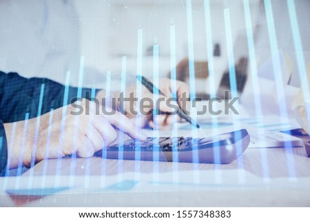 Financial trading graph double exposure with man desktop background.