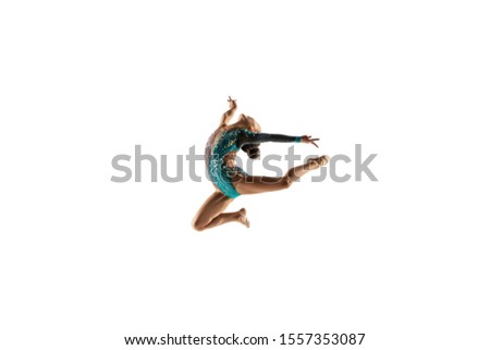 Little flexible girl isolated on white studio background. Little female model as a rhythmic gymnastics artist in bright leotard. Grace in motion, action and sport. Doing exercises in flexibility.