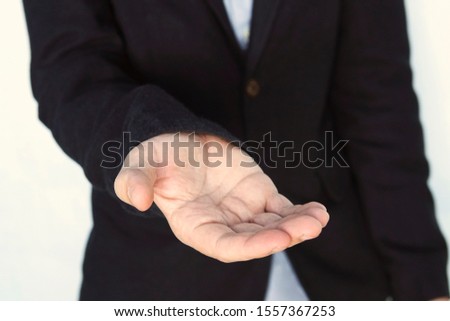 An empty workpiece. Gesture of alms begging. Businessman stretches out his hand. An adult young man asks for money. elegant gentleman lend a helping hand