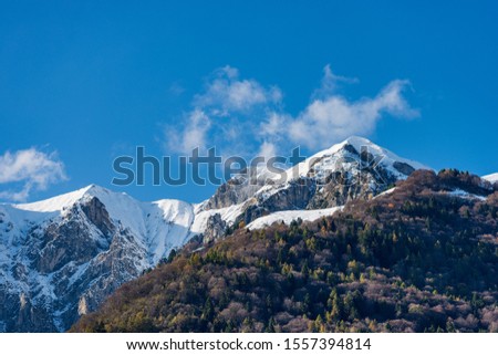 The Pichee, snow capped mountain in the Giudicarie Alps seen from the lake Tenno, Trento province, Trentino-Alto Adige, Italy, Europe