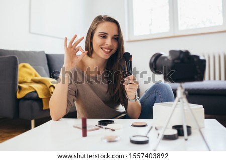 young woman influencer reviewing make-up products