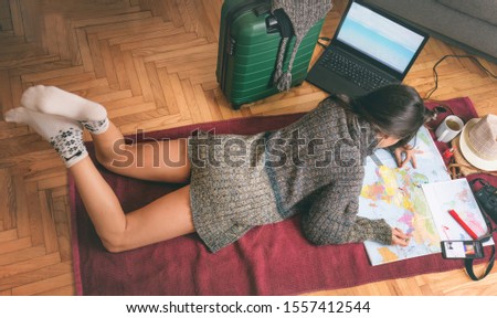 Young woman is planning her trip and summer vacation. Planning vacation image.