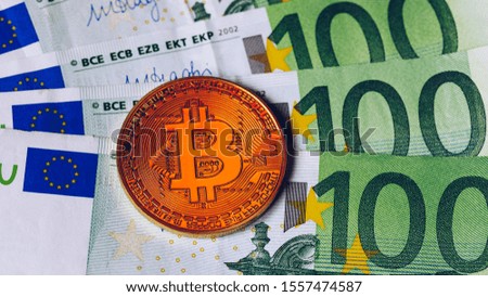 Bitcoin cryptocurrency (crypto currency) over Euro money. Golden Bitcoin symbol. Bitcoin (BTC) cryptocurrency.