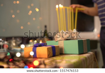 Lighting the eight candles in the menorah.  Chanukah is the Jewish eight-day, wintertime “festival of lights,” celebrated with a nightly menorah lighting, special prayers and fried foods