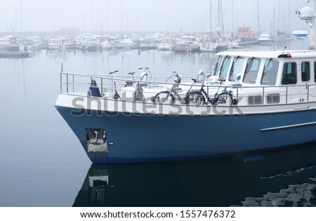 blue boat stands in the sea on the pier the theme of maritime transport and backgrounds
