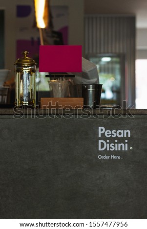 Order here sign written in malay Coffee shop counter cashierorder here sign with blank sign french press golden