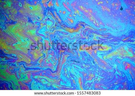 colorful rainbow oil slick background Royalty-Free Stock Photo #1557483083