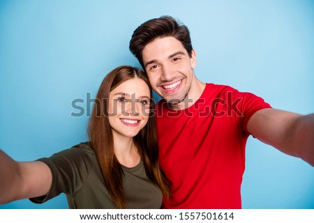 Close up photo of dreamy passionate two married people students relax rest hug embrace make selfie on summer journey wear green red t-shirt isolated over pastel color background