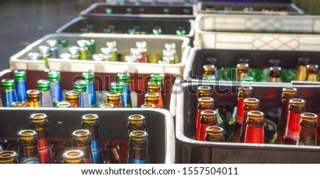 empty used beer bottles in raw of plastic boxes Royalty-Free Stock Photo #1557504011