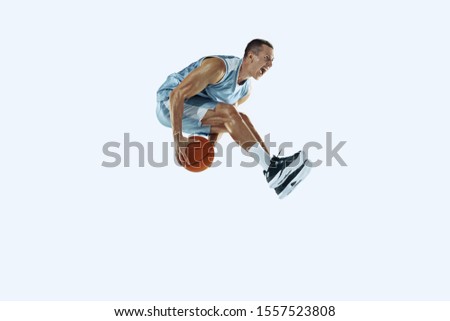 High flight. Young caucasian basketball player of team in action, motion in jump isolated on white background. Concept of sport, movement, energy and dynamic, healthy lifestyle. Training, practicing.
