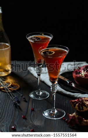 Prosecco pomegranate cocktail, garnished with dryed lemon slice