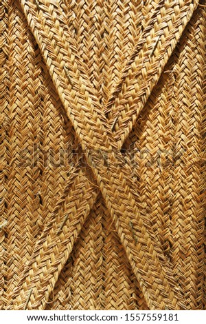 Esparto mat background in cross, modern Spanish trend of interior decoration with vegetable fiber