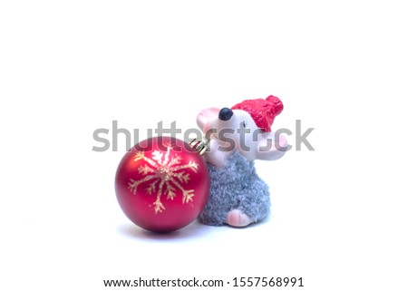 Christmas toy rat, symbol of the year, with a Christmas red ball