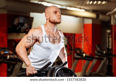 Muscular man working in gym. Sport power