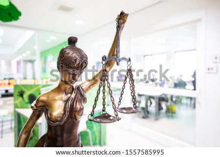 The Statue of Justice in front of a classroom on school