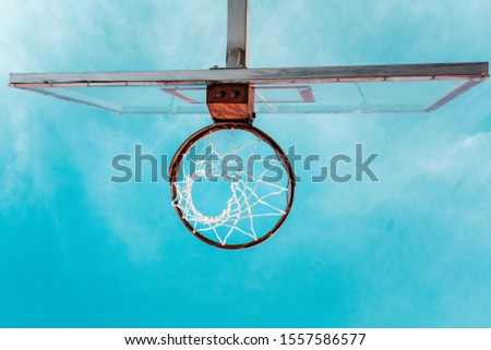 Sports and basketball. Bottom view of the basketball basket. Blue sky in the background. Copy space