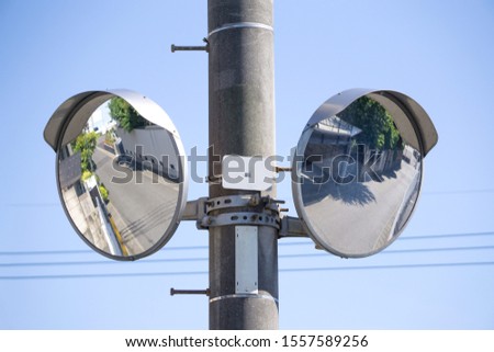 double road mirror on telegraph pole