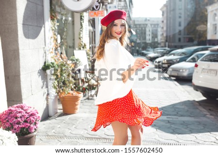 Very attractive young woman outdoors having fun. Pretty lady at urban city background. Stylish girl walking the street.