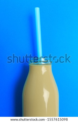 colorful bottle with straw on color background . Minimalism concept
