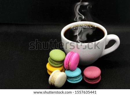 Hot coffee and macaron have colorful ia beautiful food background.