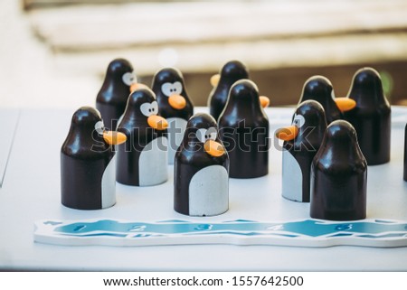 Wooden strategy game with penguin pawns