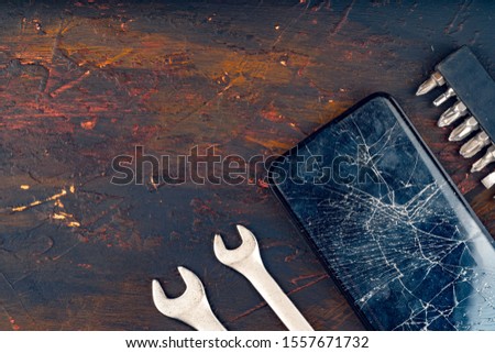Mobile smartphone with broken screen close up