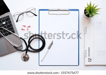 Work space medical technology and healthy concept on modern white table desk with stethoscope and laptop computer, medicine and supplies, Top view with copy space, Flat lay