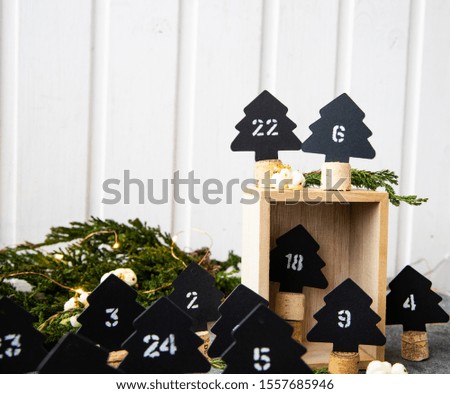Handmade Christmas advent calendar, Christmas trees paper with numbers.
