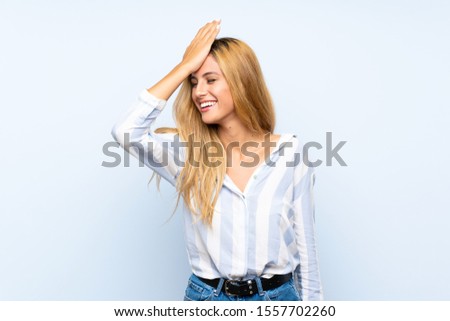 Young blonde woman over isolated blue background has realized something and intending the solution