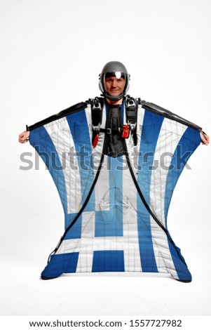 Greece flag travel. Bird Men in wing suit flag. Sky diving men in parashute. Patriotism, men and flag.
                              