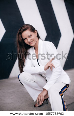 Portrait of beautiful brunette woman with makeup in fashion clothes