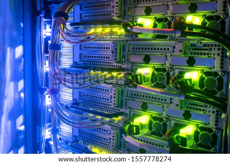 Hosting platform for modern Internet resources. Rack with server data storage equipment. Many network cables are connected to the data center equipment. Royalty-Free Stock Photo #1557778274