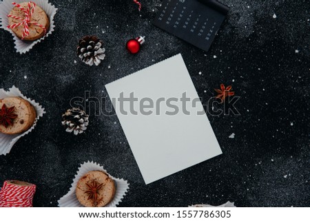 Christmas and new year composition. Creative layout made of paper blank on black background with decorations. Winter concept. Copy space