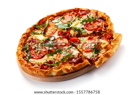 Pizza with ham, rucola, and vegetables on white background