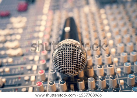 dynamic microphone on audio mixing console. broadcasting, recording concept