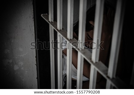 Women desperate to catch the iron prison,prisoner concept,thailand people,Hope to be free,If the violate the law would be arrested and jailed.