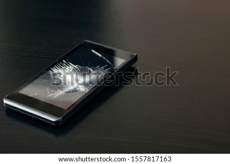 Broken display phone on a wooden table