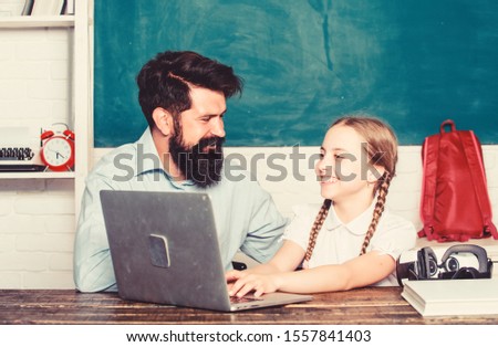 study online. small child with bearded teacher man use laptop. digital age with modern technology. daughter study with father. Formal education. innovative technology in modern school. back to school.