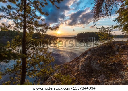 A sunset view of Eagle Lake from the top of a large granite outcropping on an unnamed island located in Northwest Ontario, Canada.