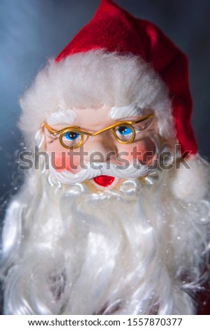 A photo of a Christmas tree ornament in the form of a Santa's head. Picture are modeled on a portrait photo style.