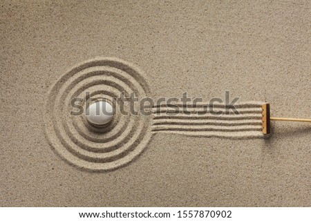 A rake in a zen rock garden, preparing the sand. Top view