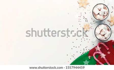Hello Christmas. Warm sweater with patterns and cups of hot cocoa with marshmallows on white background, panorama, copy space