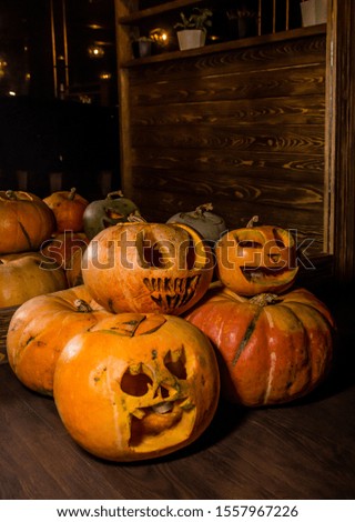 Halloween pumpkins with carved faces on the floor