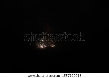 picture of firecrackers bursting and producing sparks around them