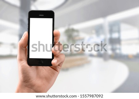 Male hand holding black cellphone, isolation white background