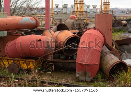 discarded old metal ducts. abandoned metal dump. factory roof Royalty-Free Stock Photo #1557991166