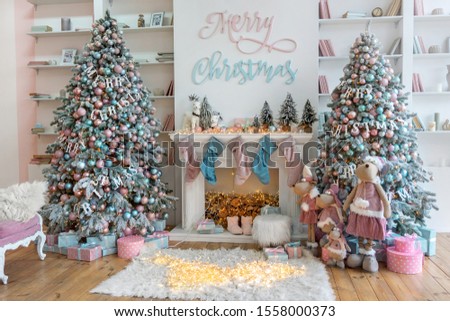 White lving room with big windows and Christmas New year decor,light garland and Christmas tree