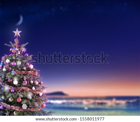 Christmas tree on beach with beautiful night background